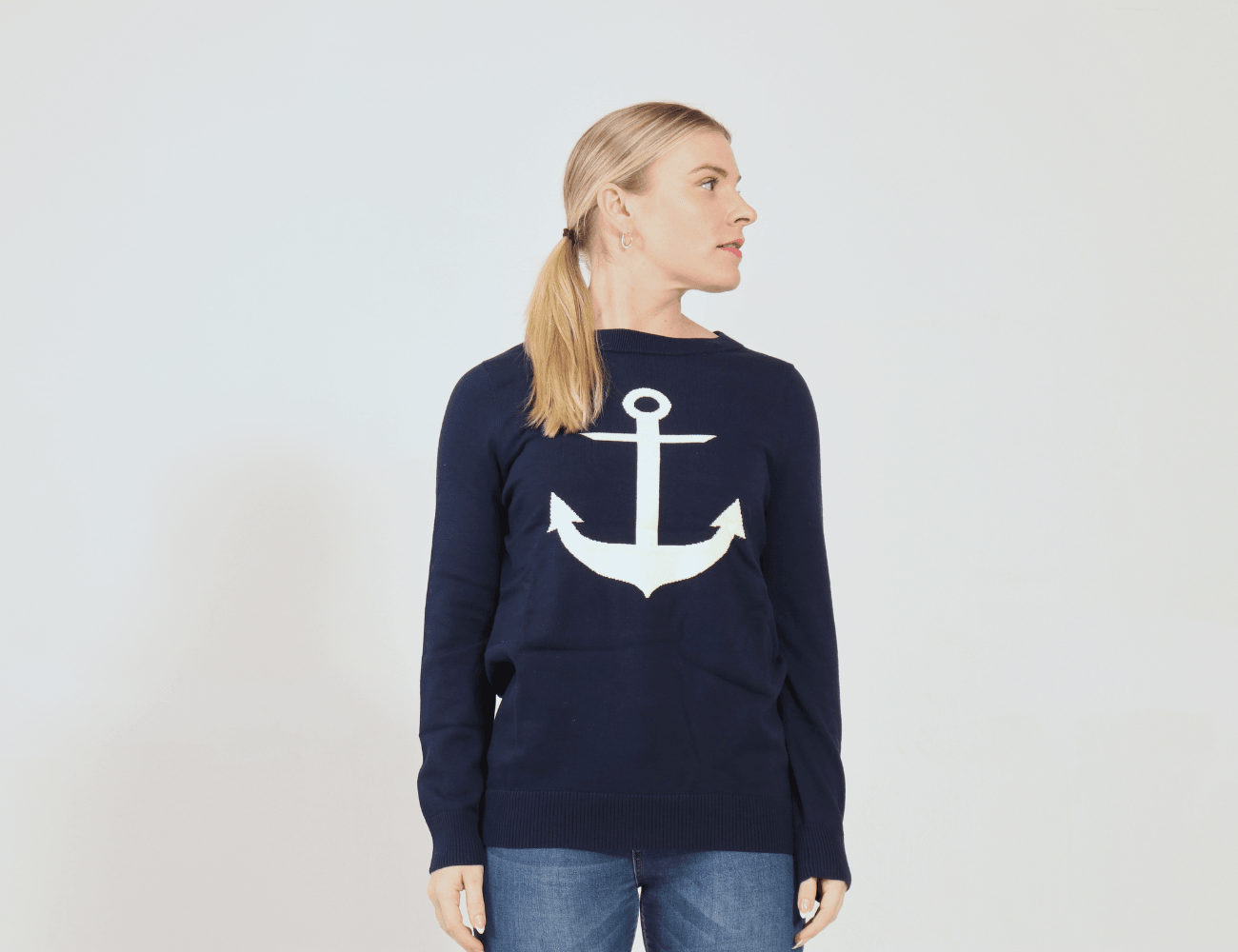 Picture of girl in navy sweater with white anchor on it.