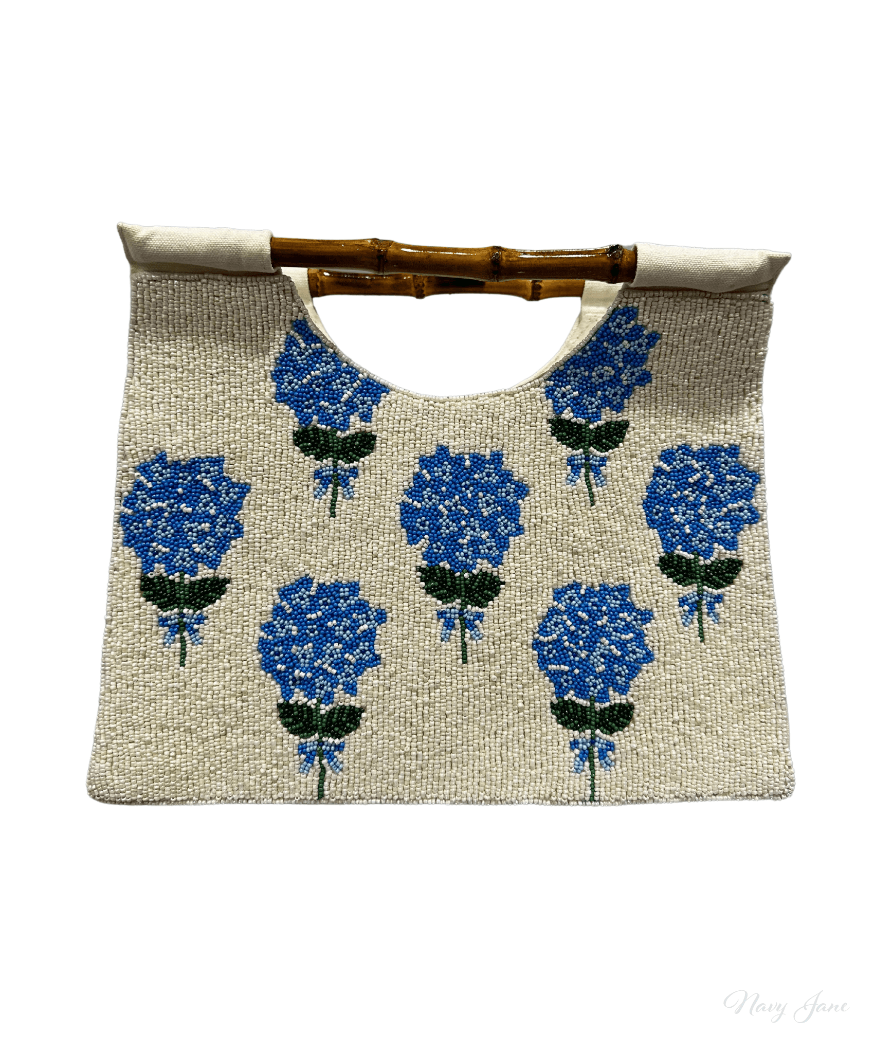 Picture of a cream beaded purse with a straight bamboo handle.