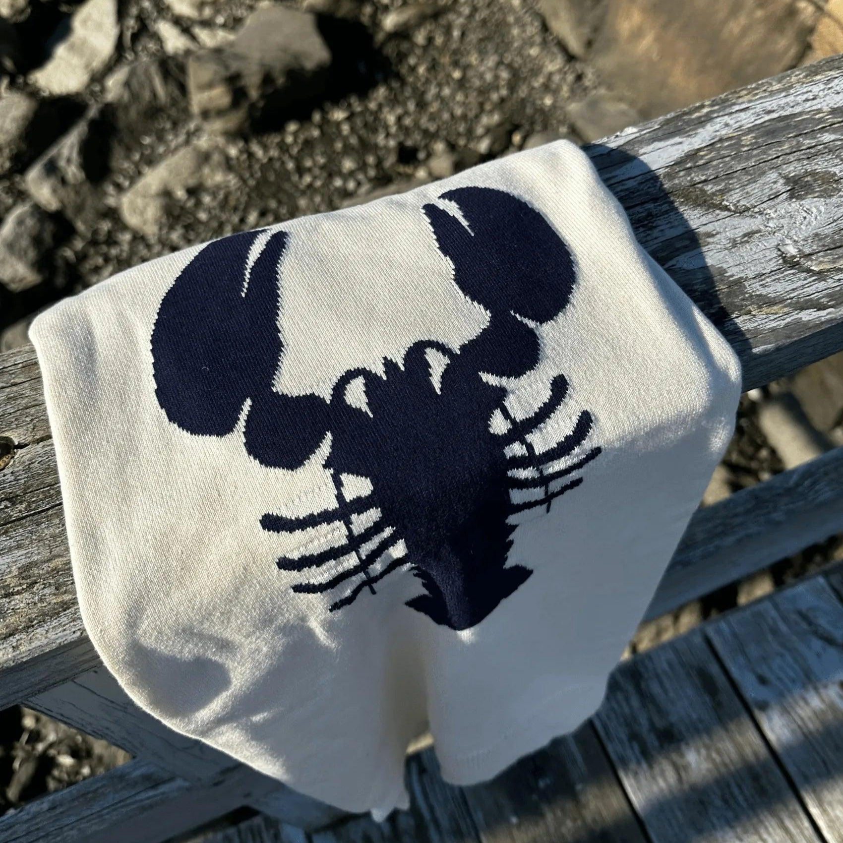 picture of a cream sweater and navy blue lobster design.