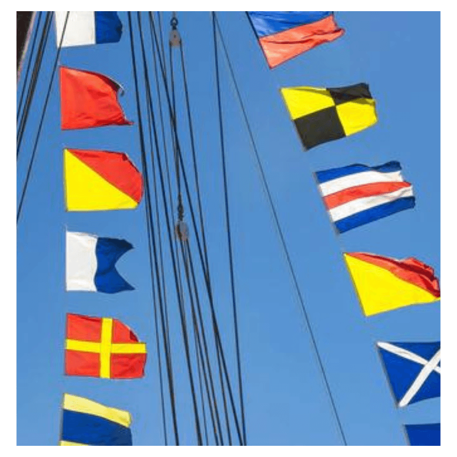 Picture of the sky with nautical flags hoisted. 