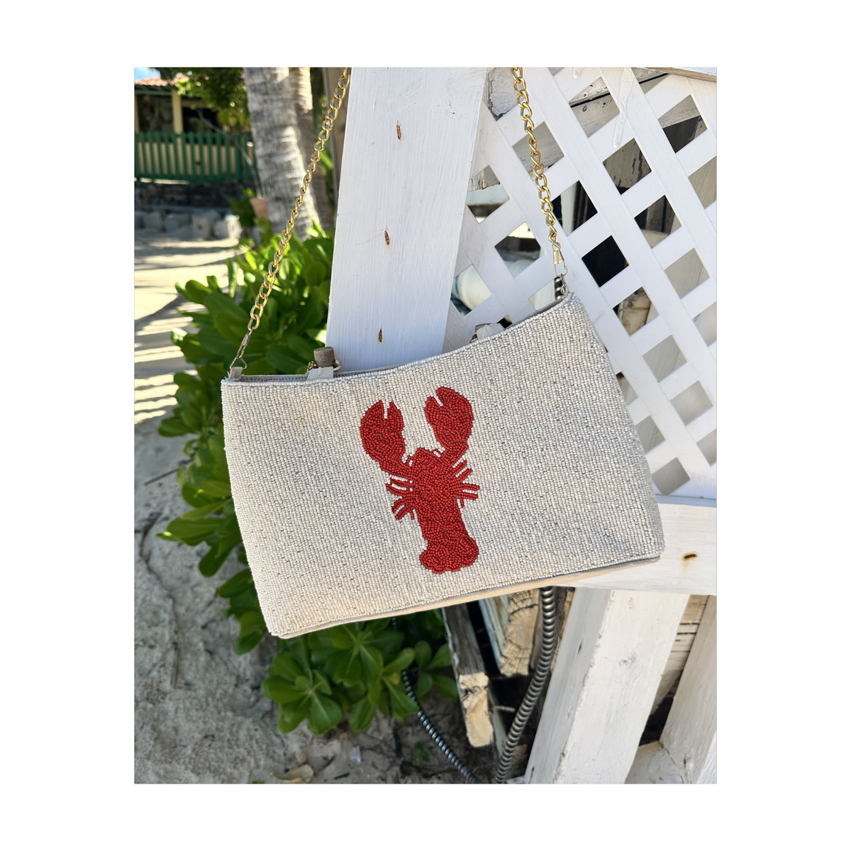 cream purse with curved bamboo handle and red lobster design