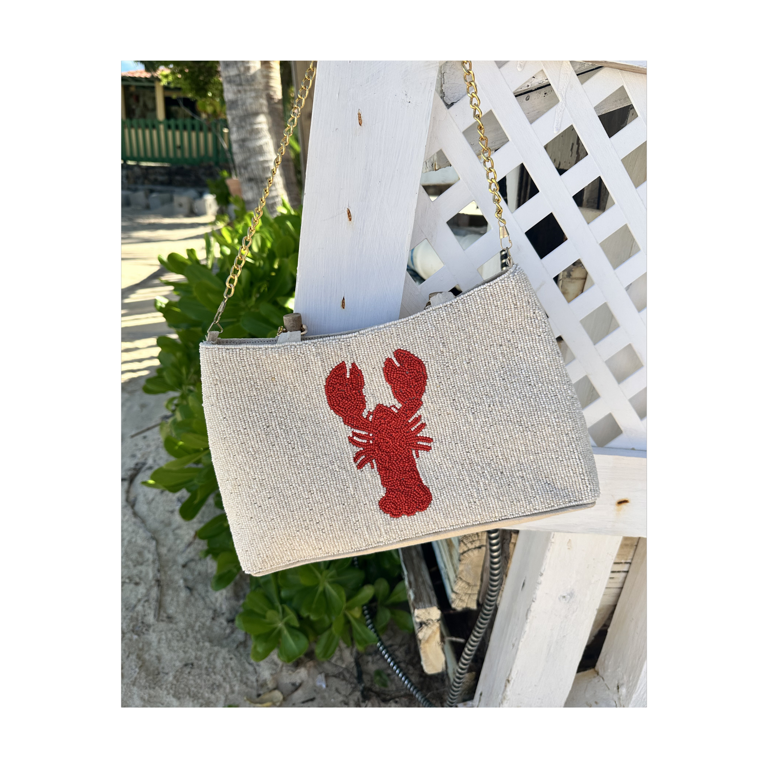 cream purse with curved bamboo handle and red lobster design
