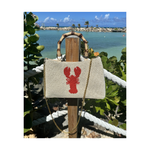 cream beaded purse with curved bamboo handle, gold chain, and red lobster design,