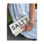 Cream Beaded Salty Clutch.  Salty is written in navy, being held by woman in a dress