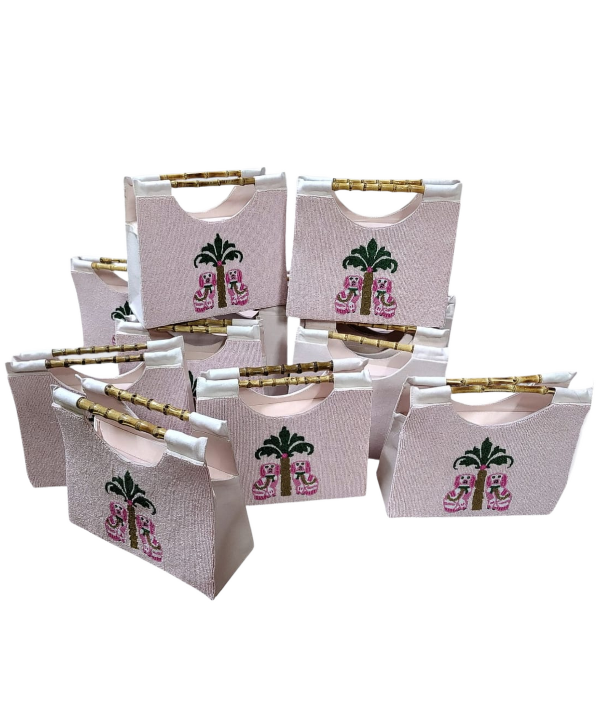 picture of many beaded pink purse with chinoiserie dalmations with a straight bamboo handle.