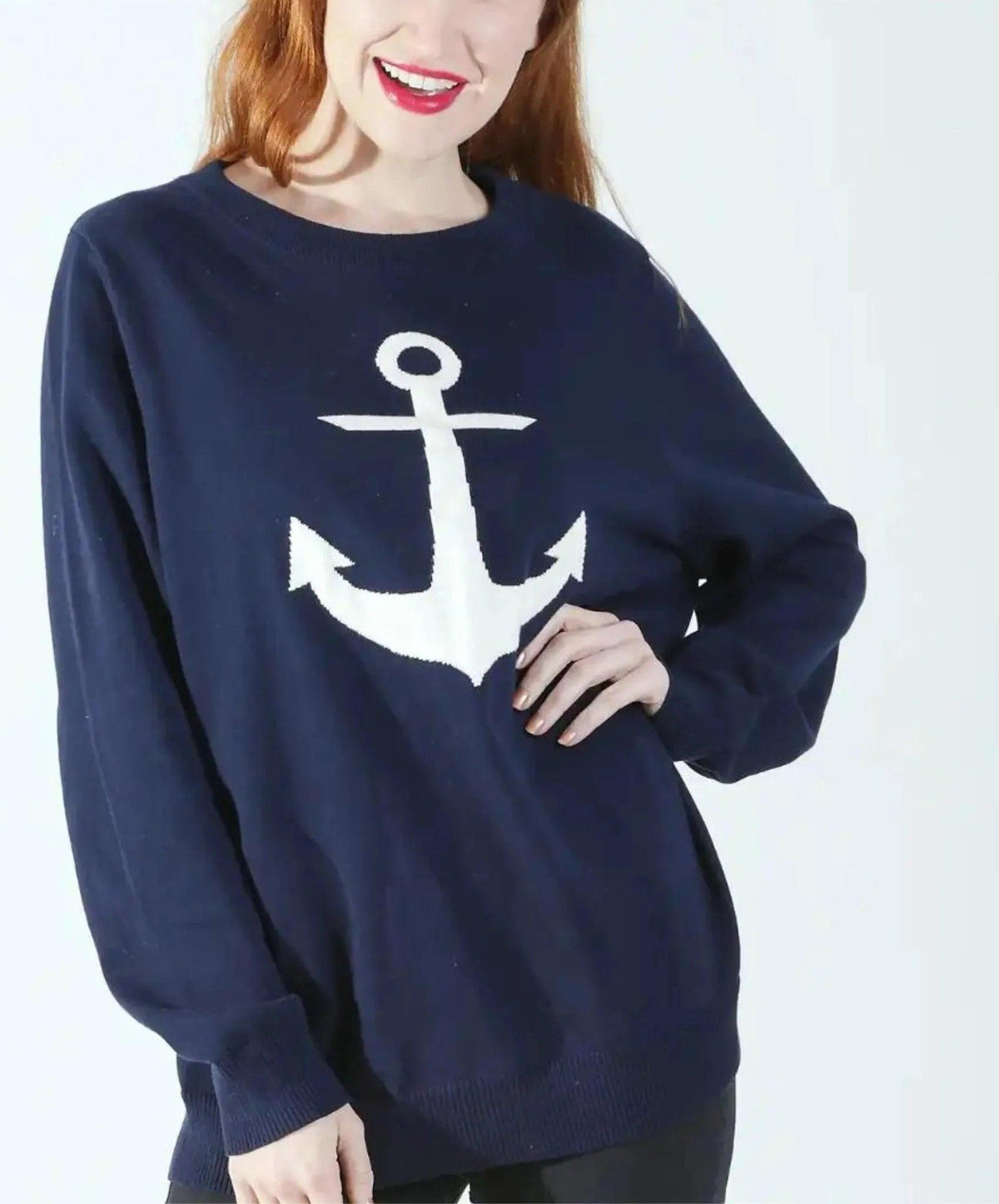 Picture of a navy sweater with a white anchor.  Clean white background