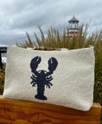 picture of cream beaded purse with navy lobster & bamboo handles. 