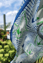 close-up picture of a silk scarf showing  blue, green, and white.  