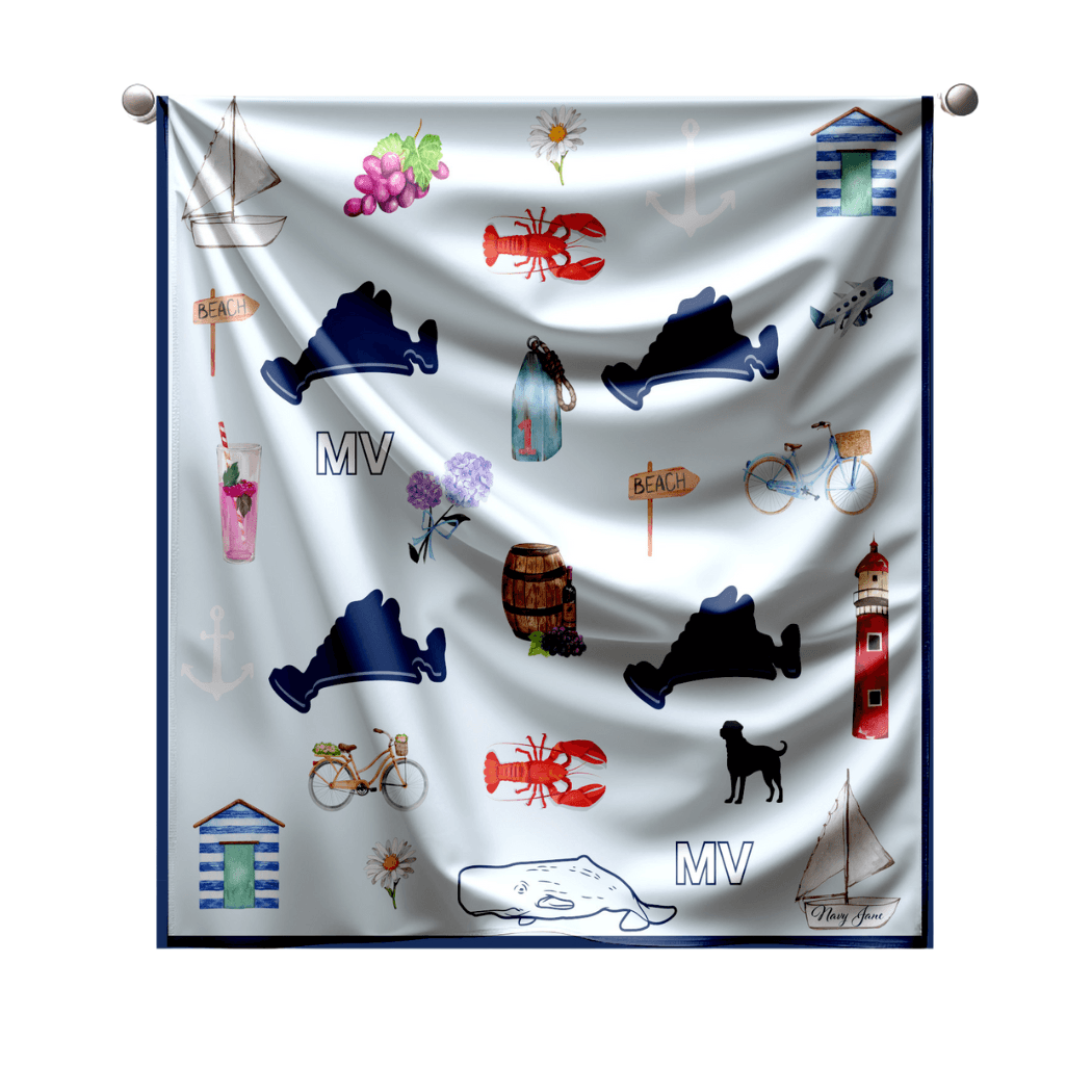 A navy and silk light blue scarf featuring various icons and symbols of Martha's Vineyard such as lighthouses and cottages.   This is sitting against a clean white background. 