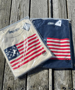 Picture of a navy sweater with American Flag sweater.  Also a picture of a cream sweater with an Americna Flag.  Both still in clear packages. 