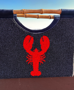 close Up of Navy Purse with REd Lobster Design and straight bamboo handles.  