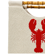 close up structured purse beaded in cream with red lobster design and straight bamboo handle on white background