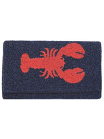 Navy blue clutch with a red lobster design on a white background