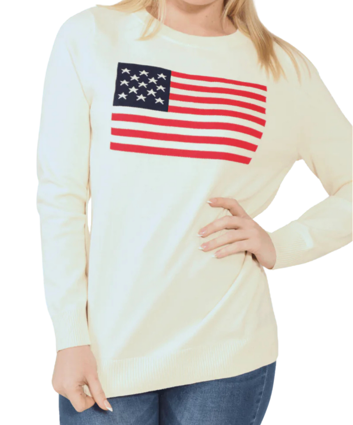 A woman wearing a cream-colored long-sleeve knit sweater with a knitted American flag design on the front.