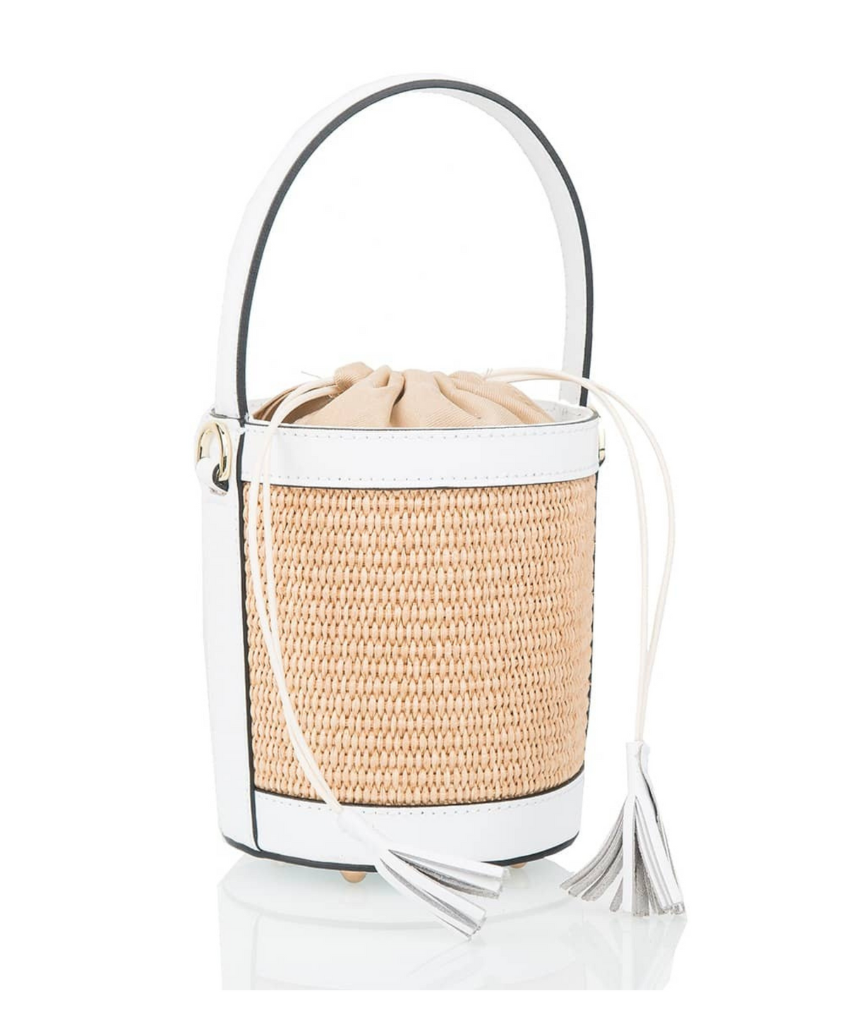 A white  raffia lucket handbag with white leather  detailing and a tassel on the drawstring top.