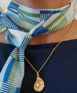 picture of a scarf with colors blue, green yellow and white.  